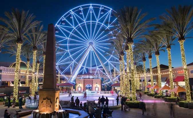 Irvine-Spectrum Illuminated Ferris wheel at winter marketplace.