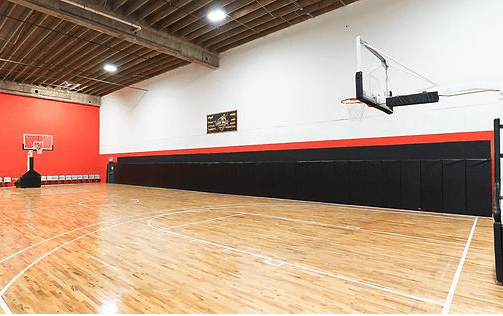 Indoor basketball court with hoop.