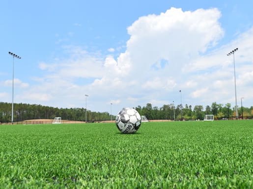 WCC_Soccer_Lights500x375 Soccer ball on a green field.